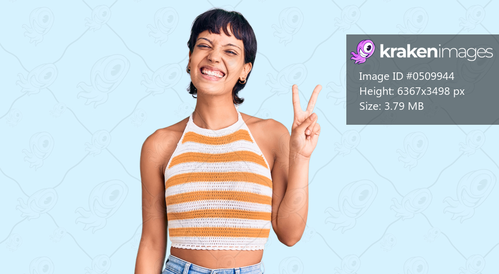 Young brunette woman with short hair wearing casual clothes showing and pointing up with fingers number two while smiling confident and happy. 