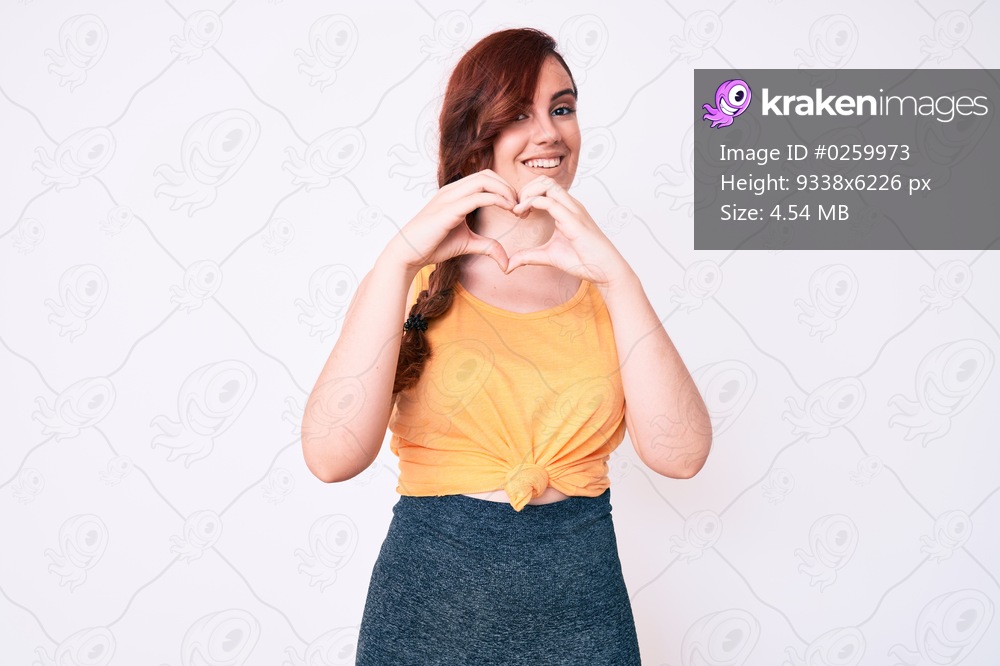 Young beautiful woman wearing casual clothes smiling in love doing heart symbol shape with hands. romantic concept. 