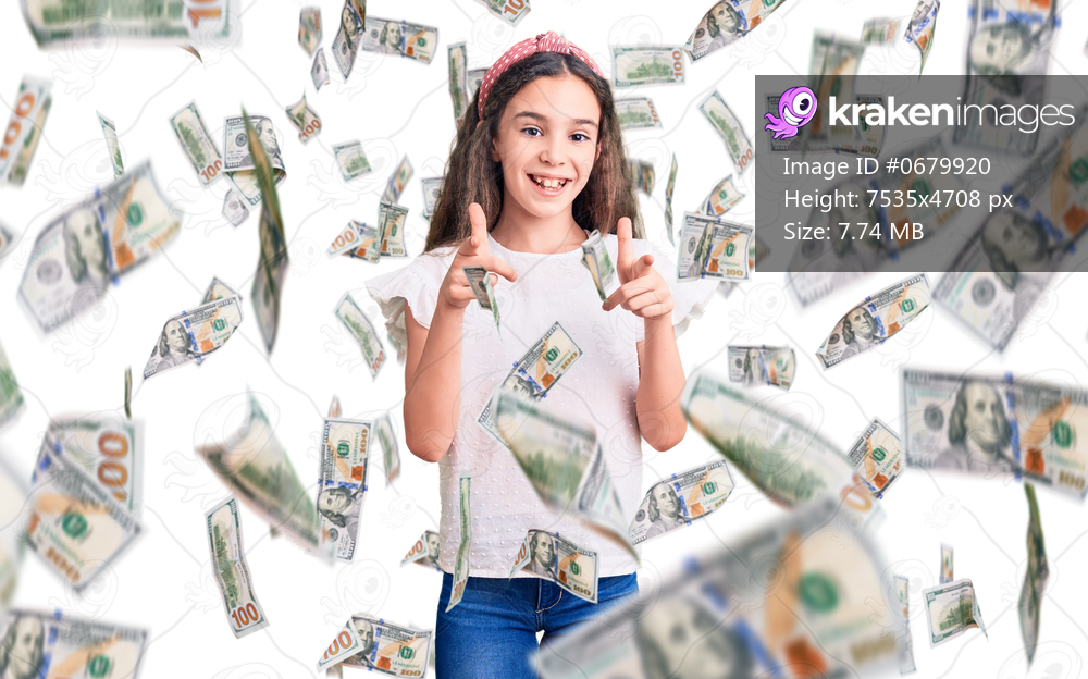 Cute hispanic child girl wearing casual white tshirt pointing fingers to camera with happy and funny face. good energy and vibes.