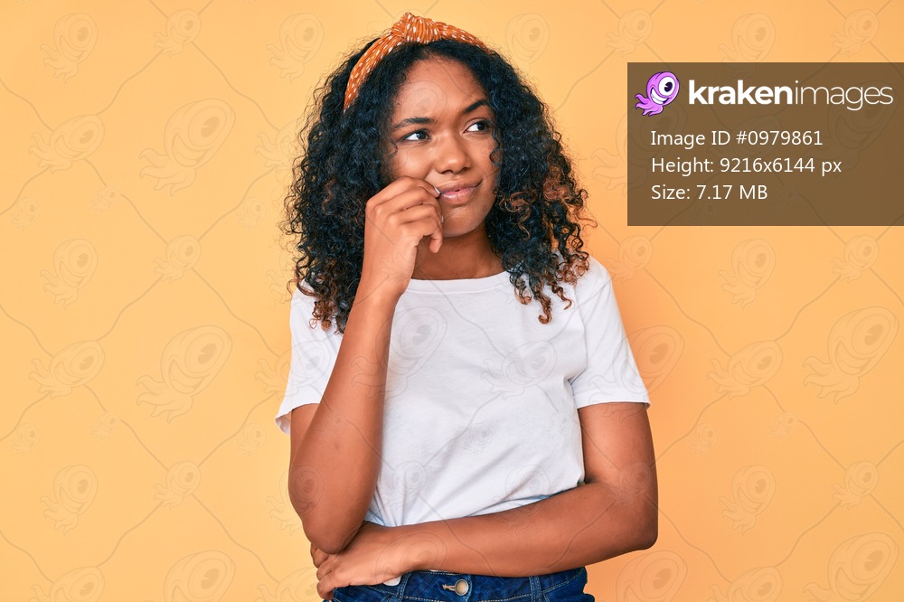 Young african american woman wearing casual clothes serious face thinking about question with hand on chin, thoughtful about confusing idea 