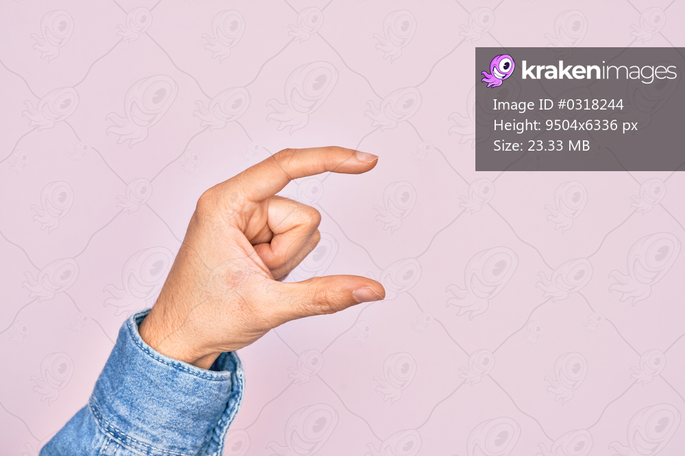 Hand of caucasian young man showing fingers over isolated pink background picking and taking invisible thing, holding object with fingers showing space