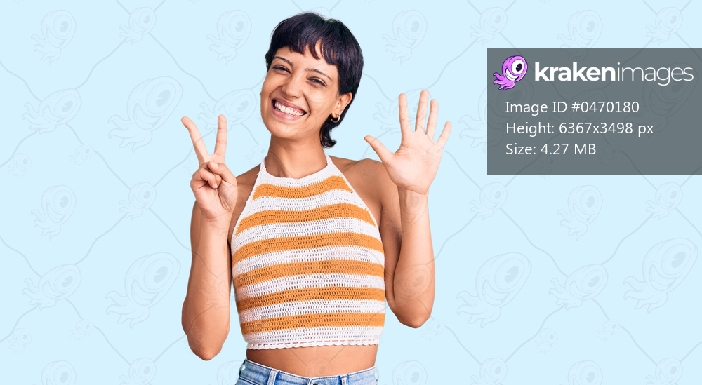 Young brunette woman with short hair wearing casual clothes showing and pointing up with fingers number seven while smiling confident and happy. 