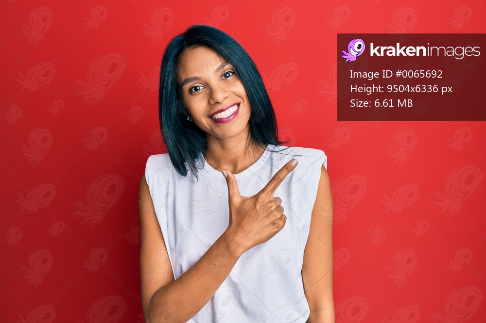 Young african american woman wearing casual clothes smiling cheerful pointing with hand and finger up to the side 