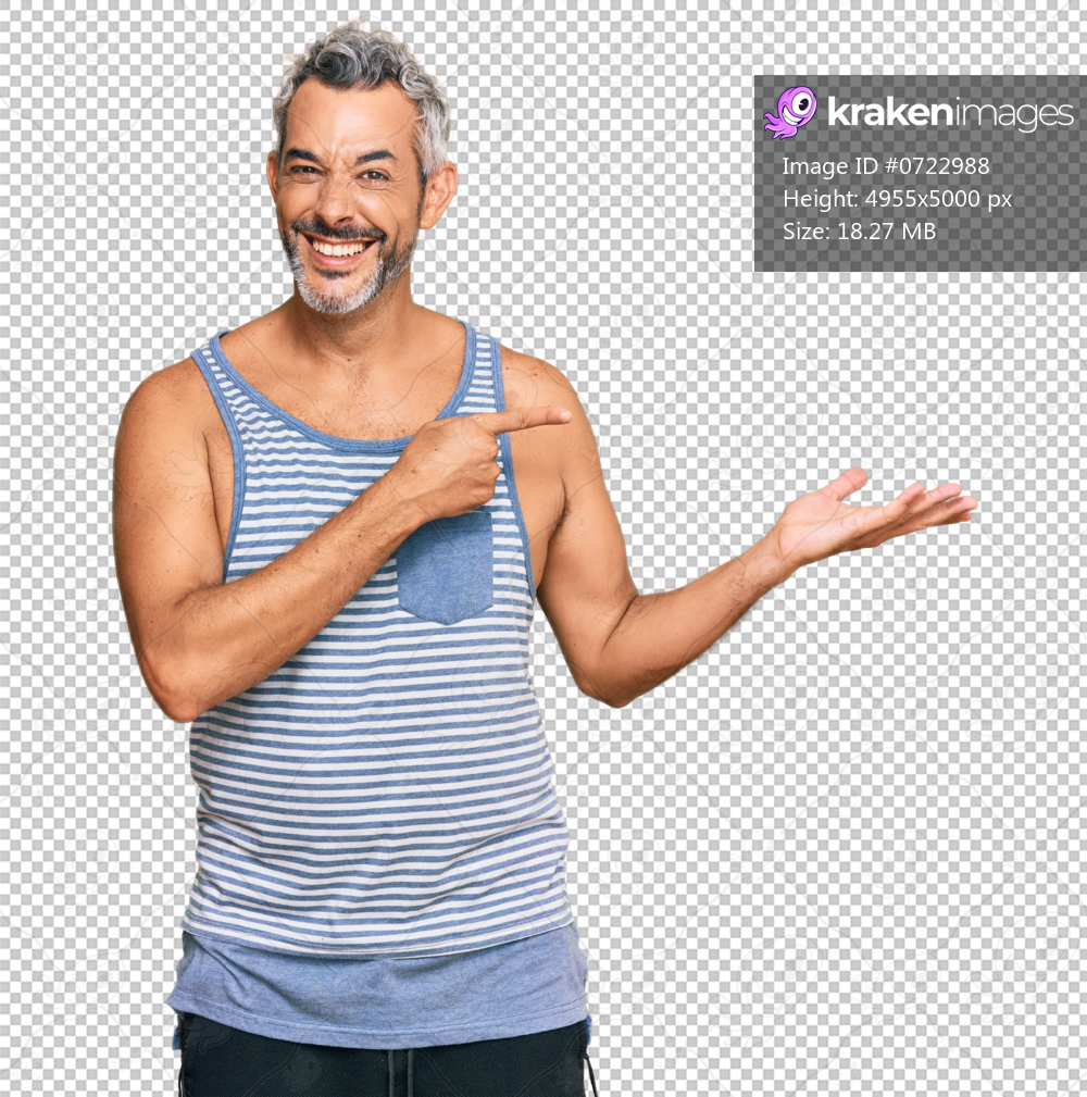 Middle age grey-haired man wearing casual style with sleeveless shirt amazed and smiling to the camera while presenting with hand and pointing with finger.