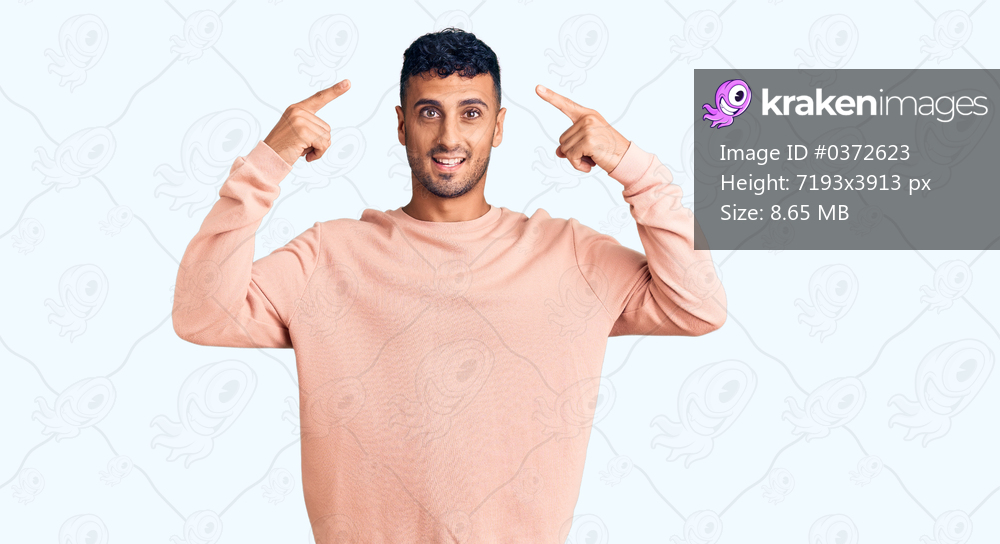 Young hispanic man wearing casual clothes smiling pointing to head with both hands finger, great idea or thought, good memory 
