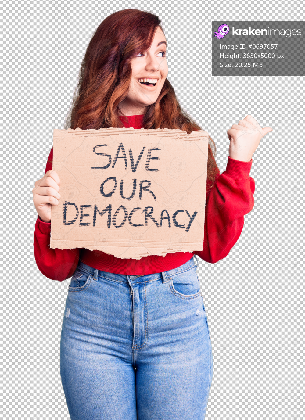 Young beautiful woman holding save our democracy protest banner pointing thumb up to the side smiling happy with open mouth
