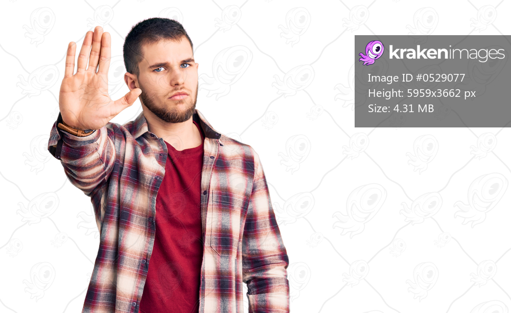 Young handsome man wearing casual shirt doing stop sing with palm of the hand. warning expression with negative and serious gesture on the face. 