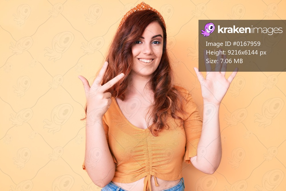 Young beautiful woman wearing casual clothes showing and pointing up with fingers number eight while smiling confident and happy. 