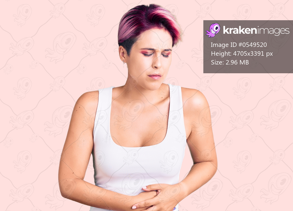 Young beautiful woman with pink hair wearing casual clothes with hand on stomach because indigestion, painful illness feeling unwell. ache concept. 