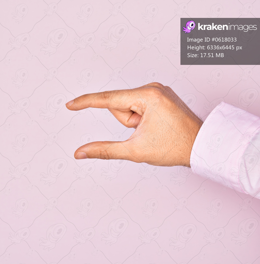 Hand of caucasian young man showing fingers over isolated pink background picking and taking invisible thing, holding object with fingers showing space