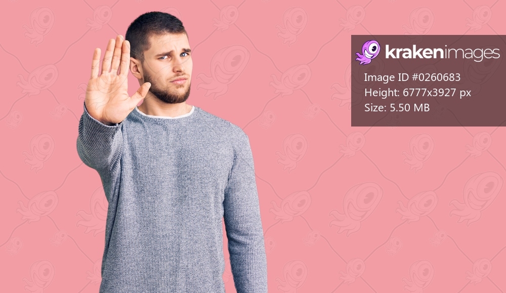 Young handsome man wearing casual sweater doing stop sing with palm of the hand. warning expression with negative and serious gesture on the face. 