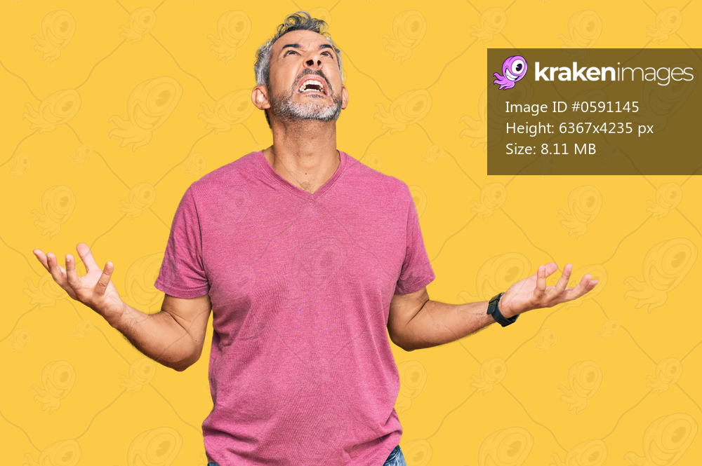 Middle age grey-haired man wearing casual clothes crazy and mad shouting and yelling with aggressive expression and arms raised. frustration concept. 