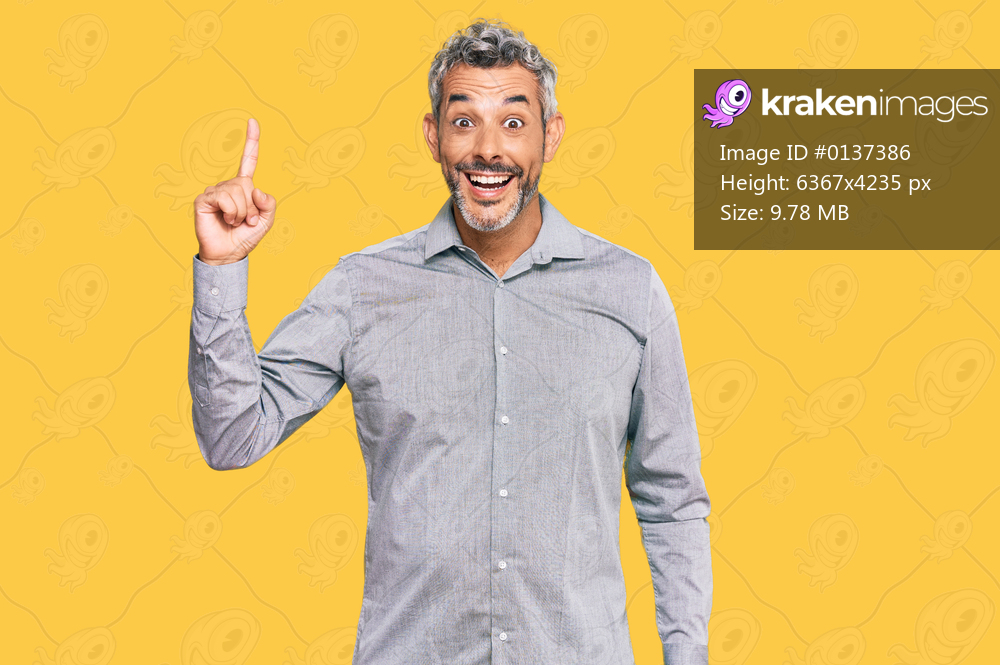 Middle age grey-haired man wearing casual clothes pointing finger up with successful idea. exited and happy. number one. 