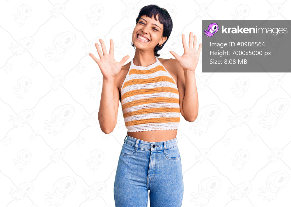 Young brunette woman with short hair wearing casual clothes showing and pointing up with fingers number ten while smiling confident and happy. 