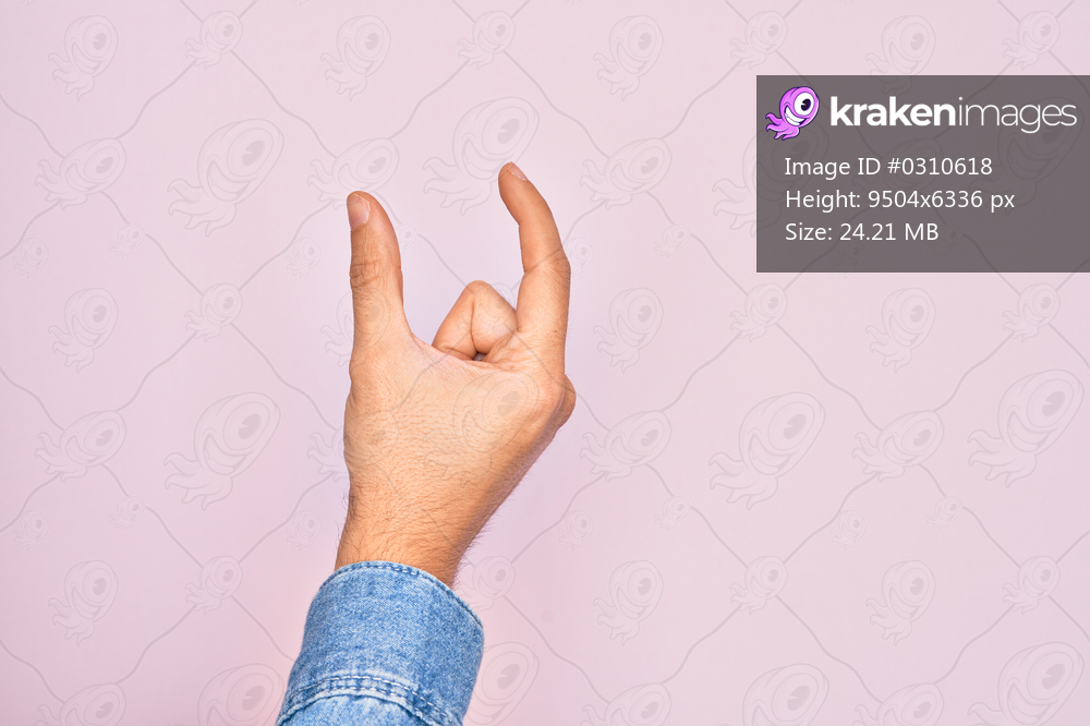 Hand of caucasian young man showing fingers over isolated pink background picking and taking invisible thing, holding object with fingers showing space