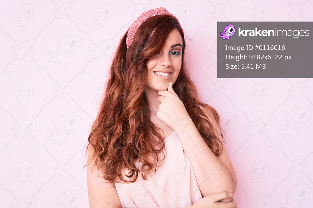 Young beautiful woman wearing casual clothes looking confident at the camera smiling with crossed arms and hand raised on chin. thinking positive. 