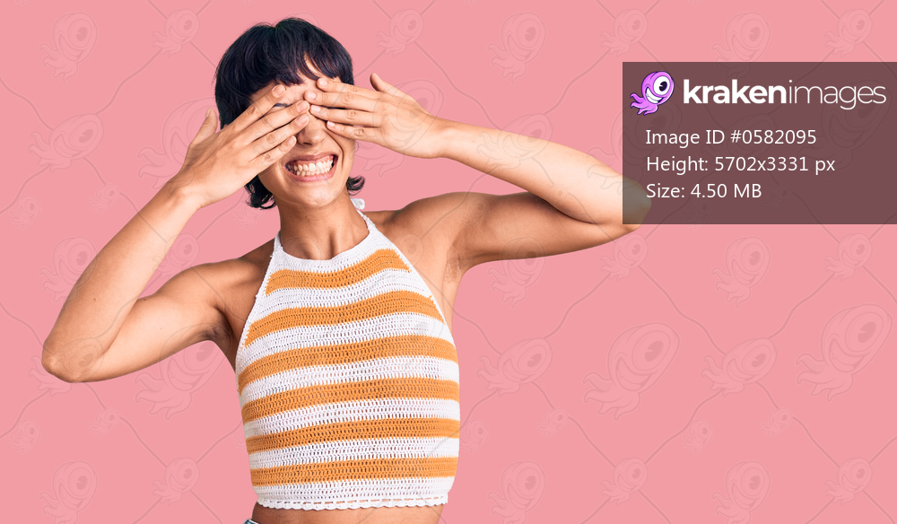 Young brunette woman with short hair wearing casual clothes covering eyes with hands smiling cheerful and funny. blind concept. 