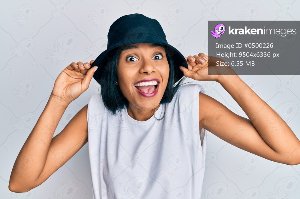 Young african american woman wearing fashion hat celebrating crazy and amazed for success with open eyes screaming excited. 