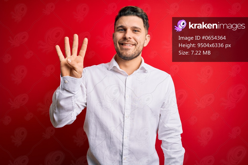 Young business man with blue eyes wearing elegant shirt standing over red isolated background showing and pointing up with fingers number four while smiling confident and happy.