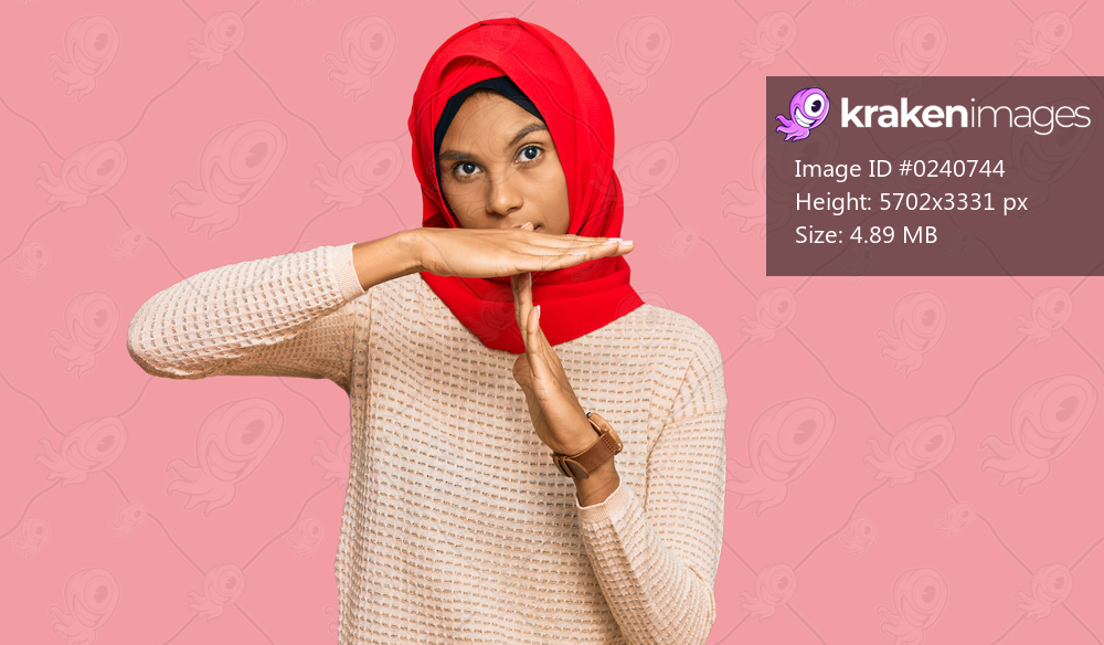 Young african american woman wearing traditional islamic hijab scarf doing time out gesture with hands, frustrated and serious face 