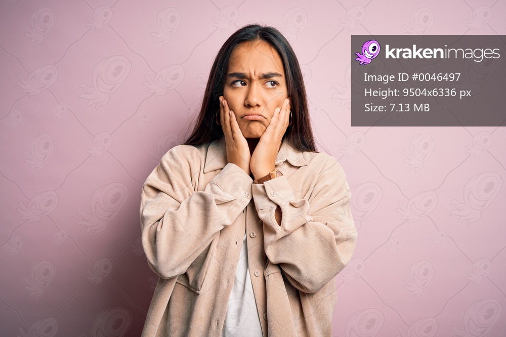 Young beautiful asian woman wearing casual shirt standing over pink background Tired hands covering face, depression and sadness, upset and irritated for problem