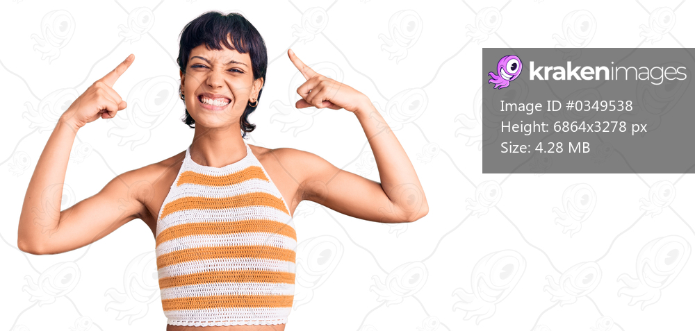 Young brunette woman with short hair wearing casual clothes smiling pointing to head with both hands finger, great idea or thought, good memory 