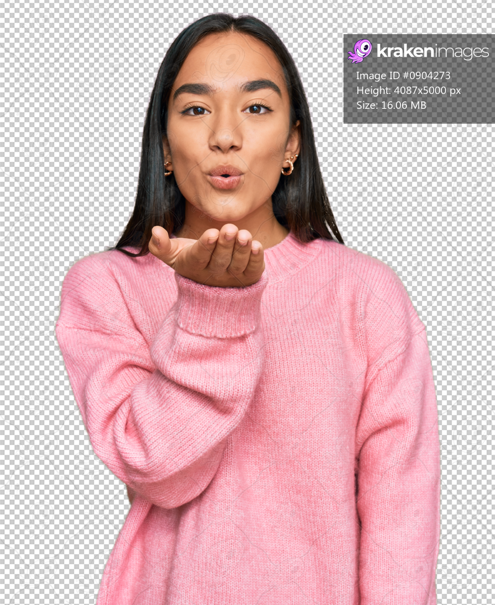 Young asian woman wearing casual winter sweater looking at the camera blowing a kiss with hand on air being lovely and sexy. love expression.