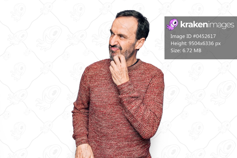 Middle age handsome man wearing casual sweater standing over isolated white background thinking concentrated about doubt with finger on chin and looking up wondering