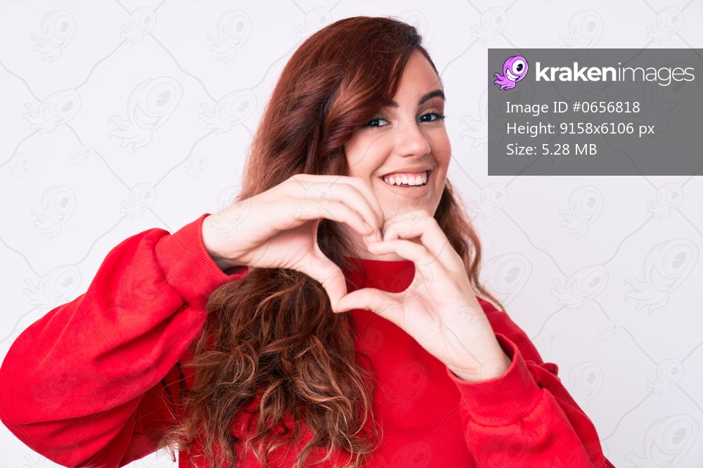 Young beautiful woman wearing casual clothes smiling in love doing heart symbol shape with hands. romantic concept. 