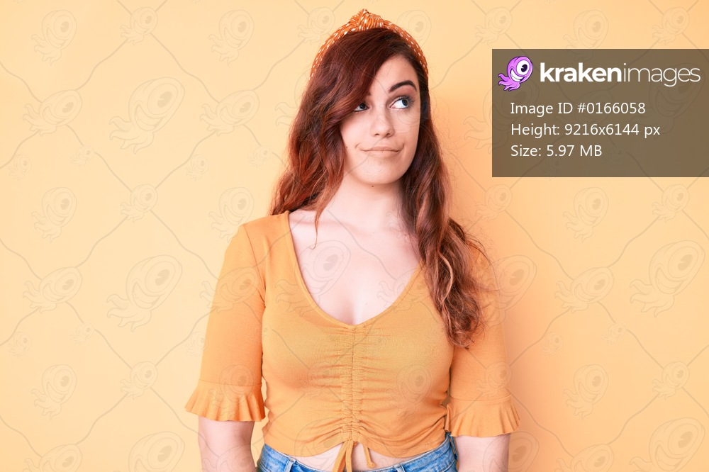 Young beautiful woman wearing casual clothes smiling looking to the side and staring away thinking. 