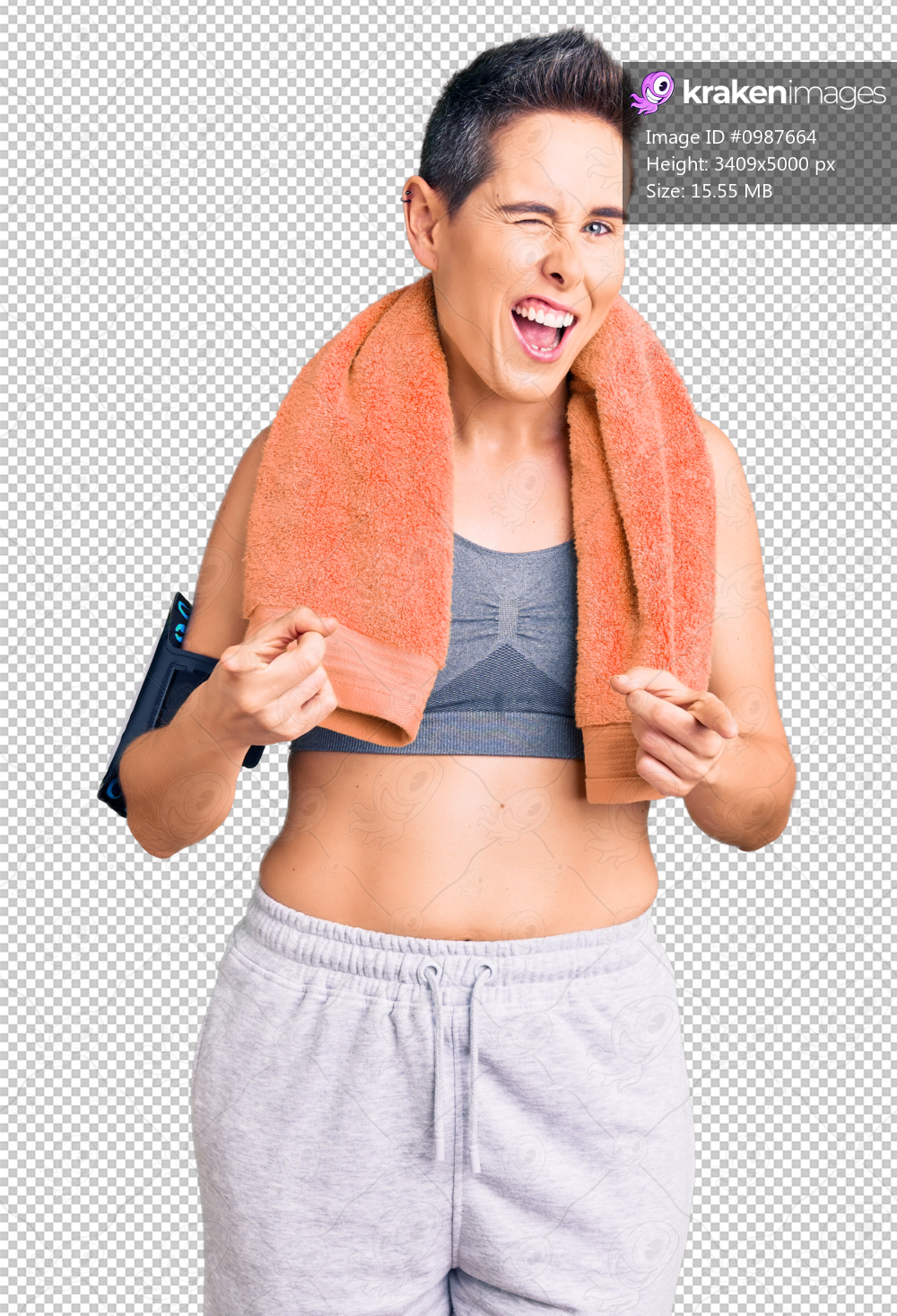 Young woman with short hair wearing sportswear and towel using smartphone pointing fingers to camera with happy and funny face. good energy and vibes.