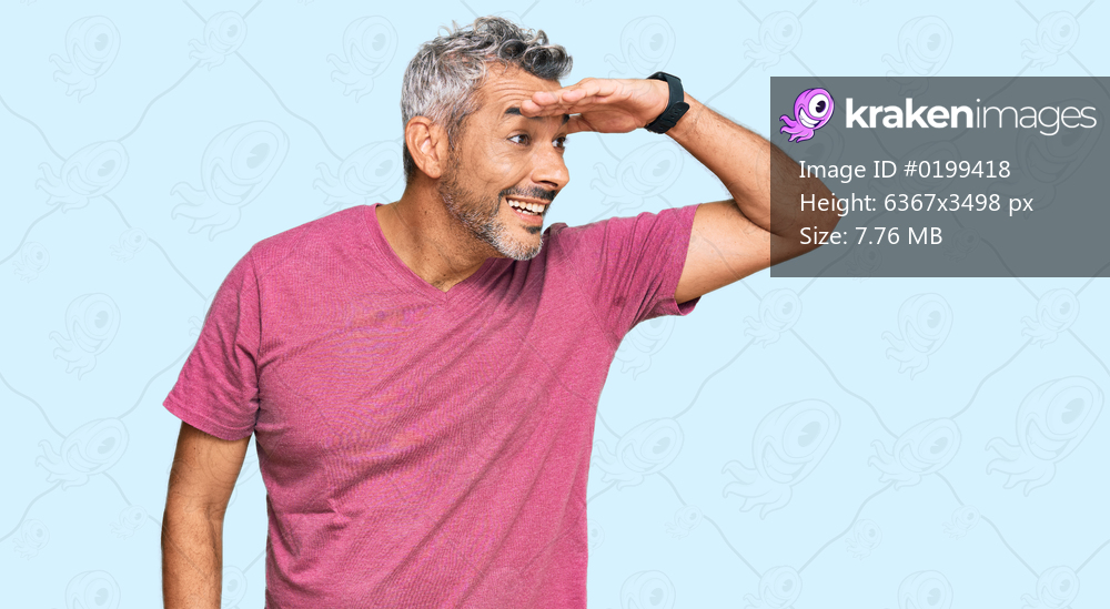 Middle age grey-haired man wearing casual clothes very happy and smiling looking far away with hand over head. searching concept. 