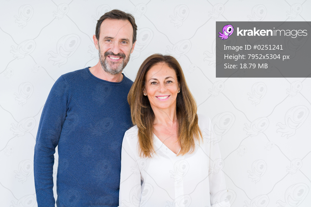 Beautiful middle age couple in love over isolated background with a happy and cool smile on face. Lucky person.