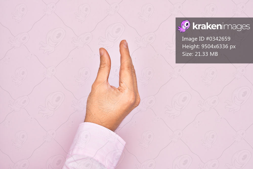 Hand of caucasian young man showing fingers over isolated pink background picking and taking invisible thing, holding object with fingers showing space