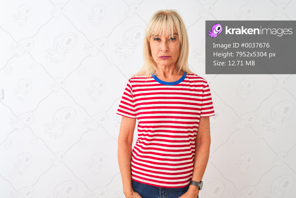 Middle age woman wearing casual striped t-shirt standing over isolated white background skeptic and nervous, frowning upset because of problem. Negative person.