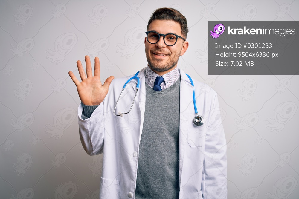 Young doctor man with blue eyes wearing medical coat and stethoscope over isolated background showing and pointing up with fingers number five while smiling confident and happy.