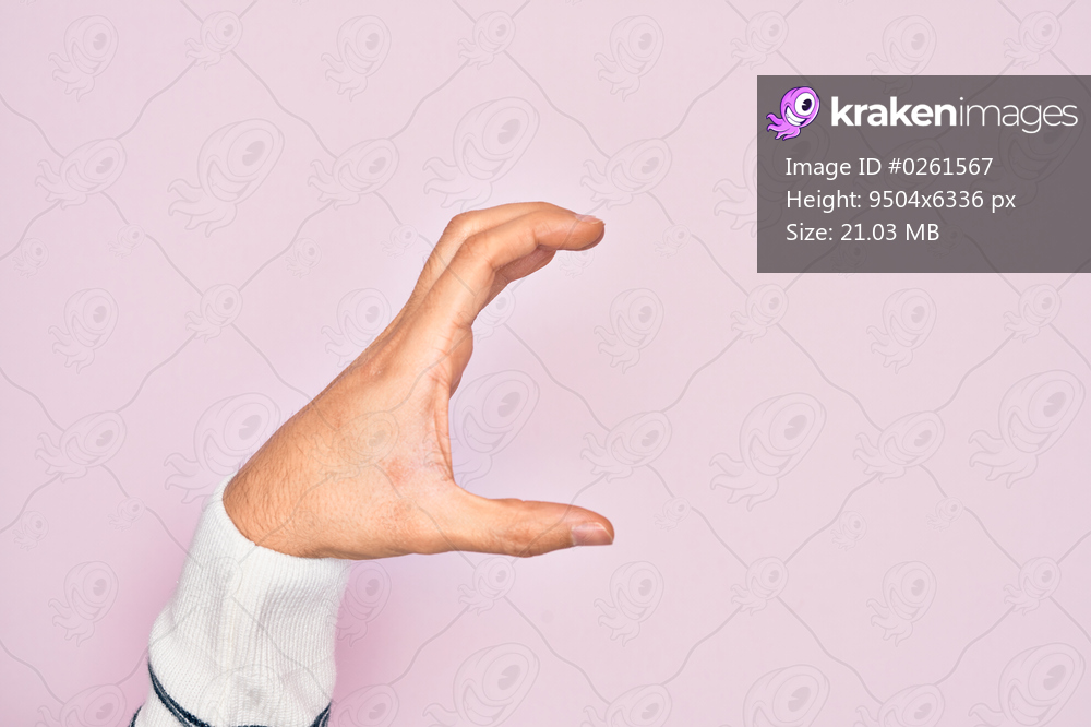 Hand of caucasian young man showing fingers over isolated pink background picking and taking invisible thing, holding object with fingers showing space