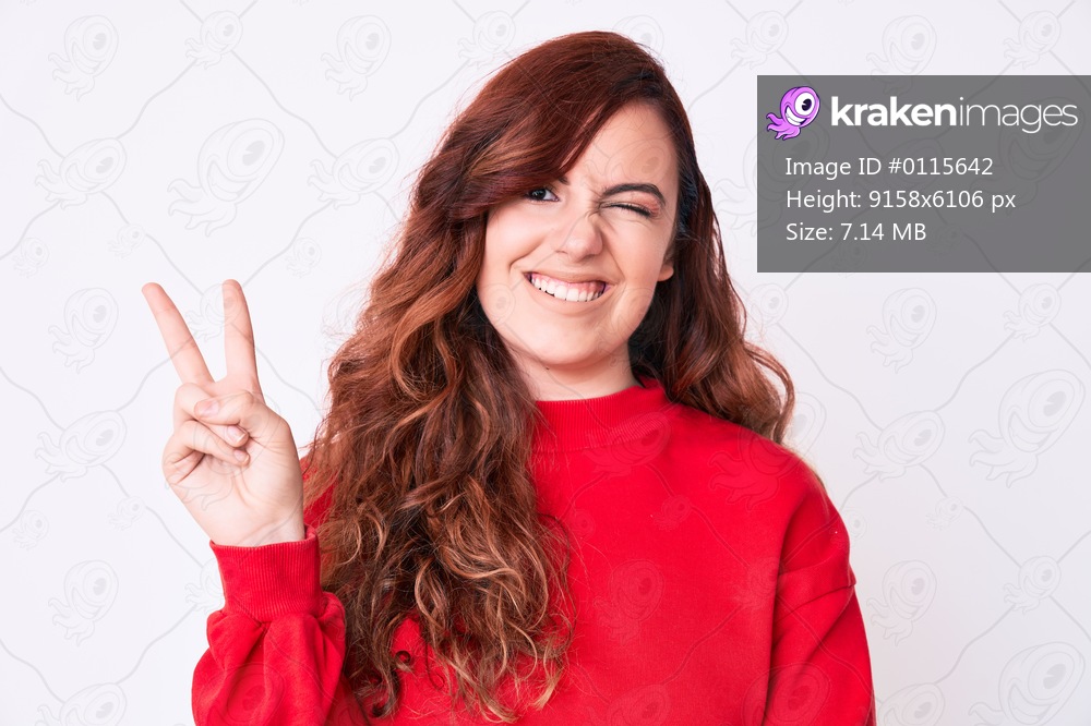 Young beautiful woman wearing casual clothes smiling with happy face winking at the camera doing victory sign. number two. 