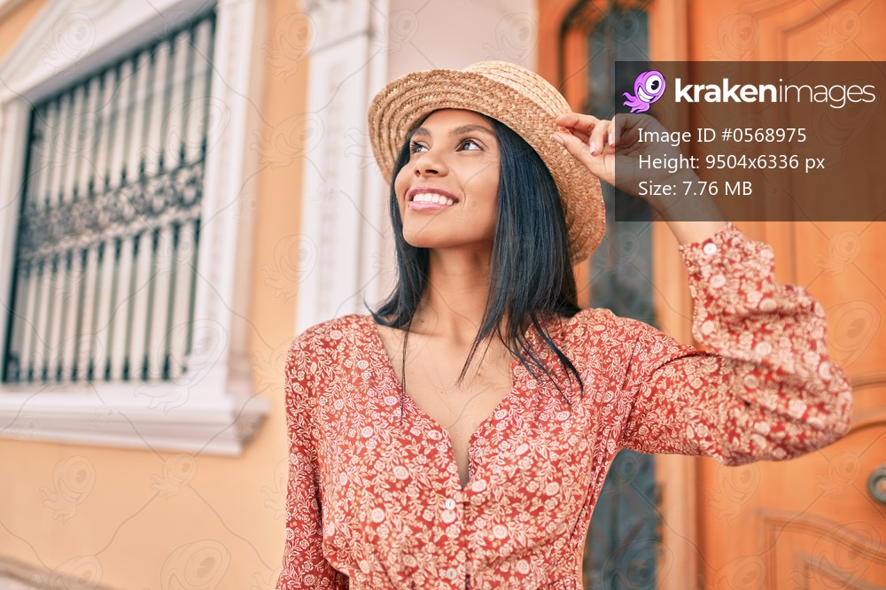 Young african american tourist woman on vacation smiling happy walking at the city.