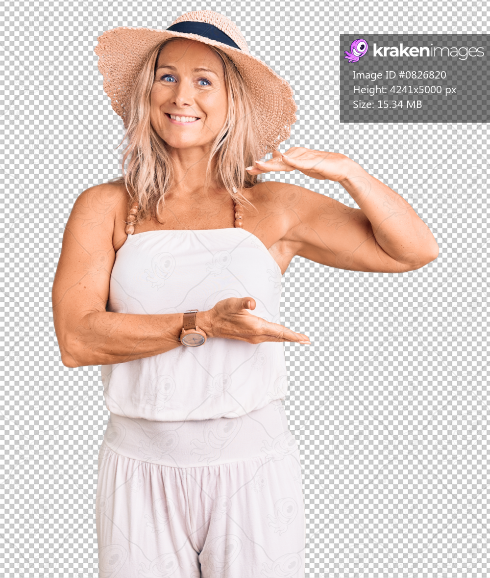 Middle age fit blonde woman wearing summer hat gesturing with hands showing big and large size sign, measure symbol. smiling looking at the camera. measuring concept.