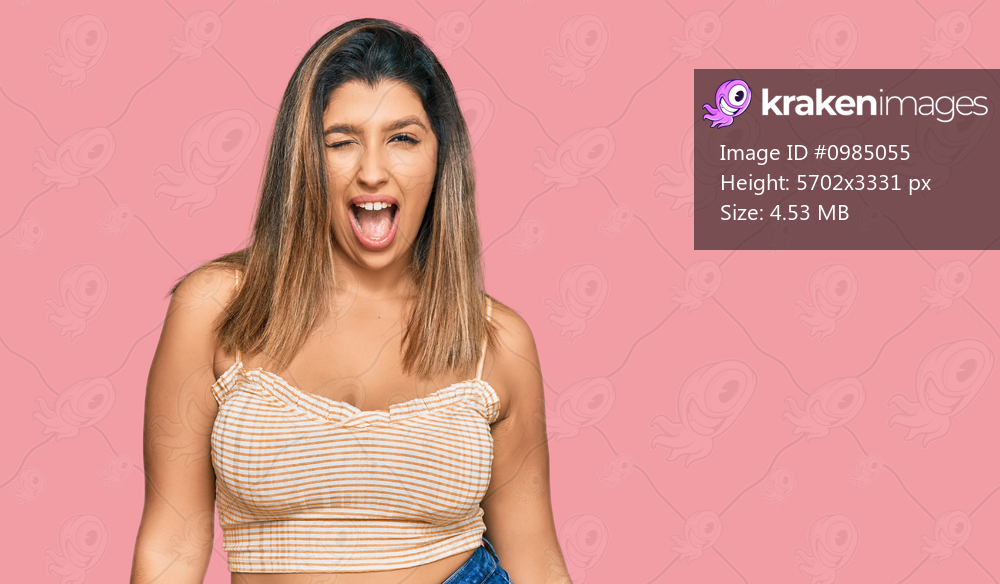 Beautiful brunette woman wearing casual clothes winking looking at the camera with sexy expression, cheerful and happy face. 