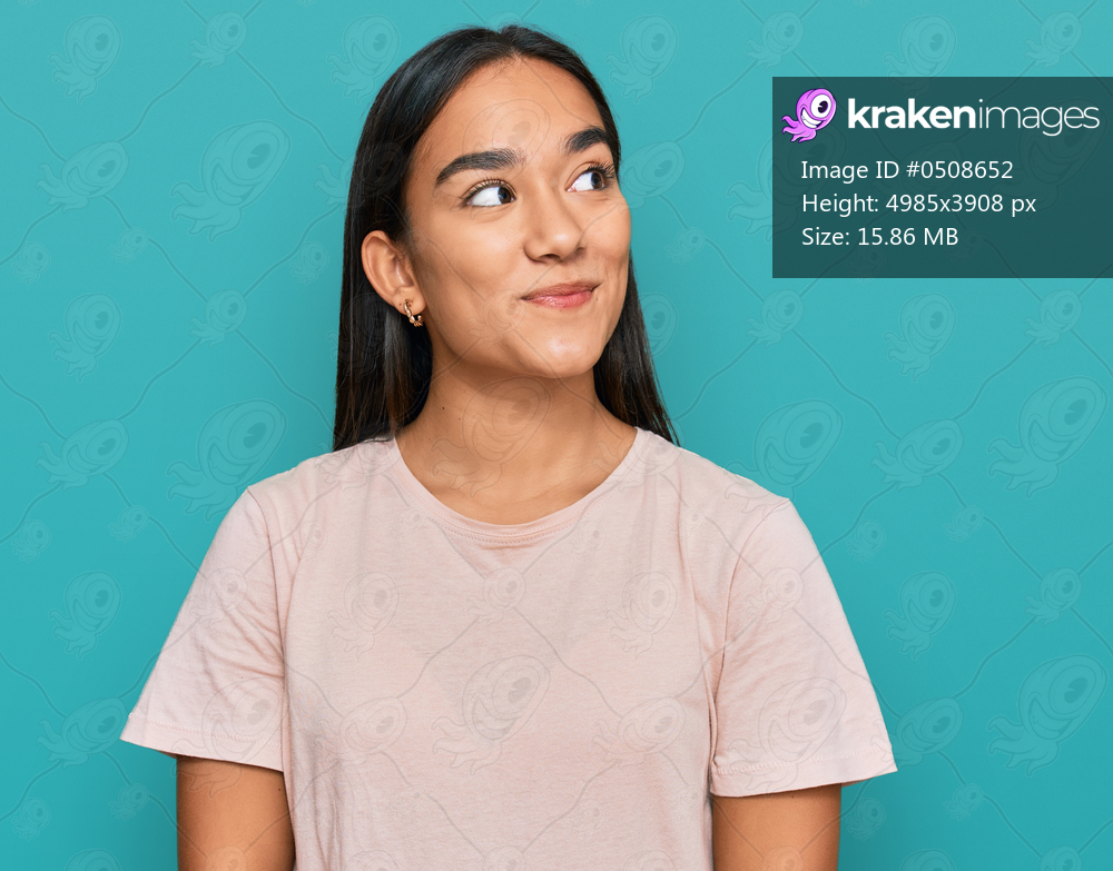 Young asian woman wearing casual clothes smiling looking to the side and staring away thinking. 