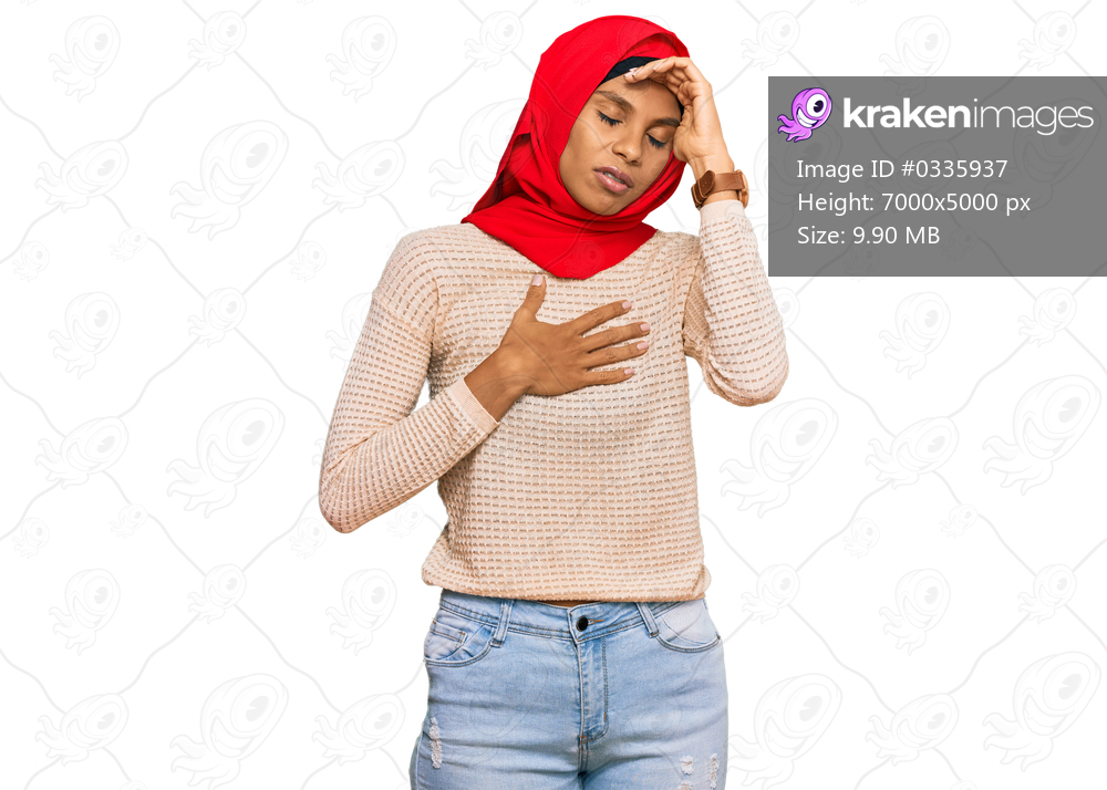 Young african american woman wearing traditional islamic hijab scarf touching forehead for illness and fever, flu and cold, virus sick 