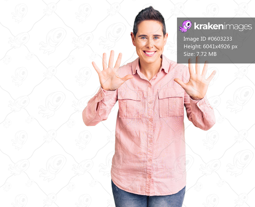 Young woman with short hair wearing casual clothes showing and pointing up with fingers number ten while smiling confident and happy. 