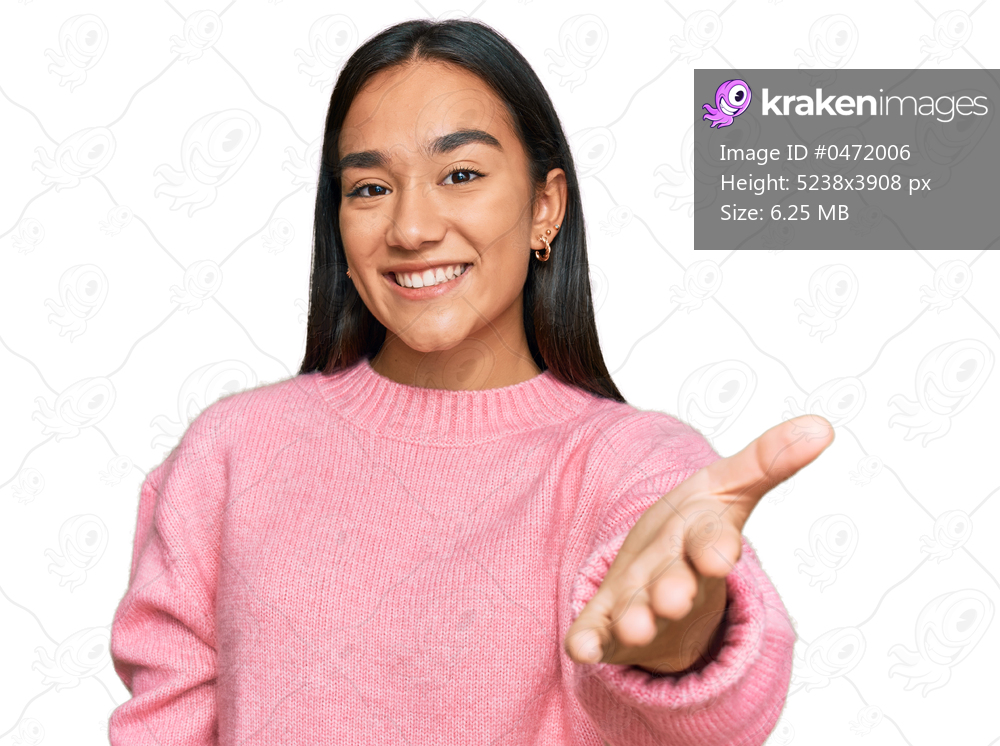 Young asian woman wearing casual winter sweater smiling cheerful offering palm hand giving assistance and acceptance. 