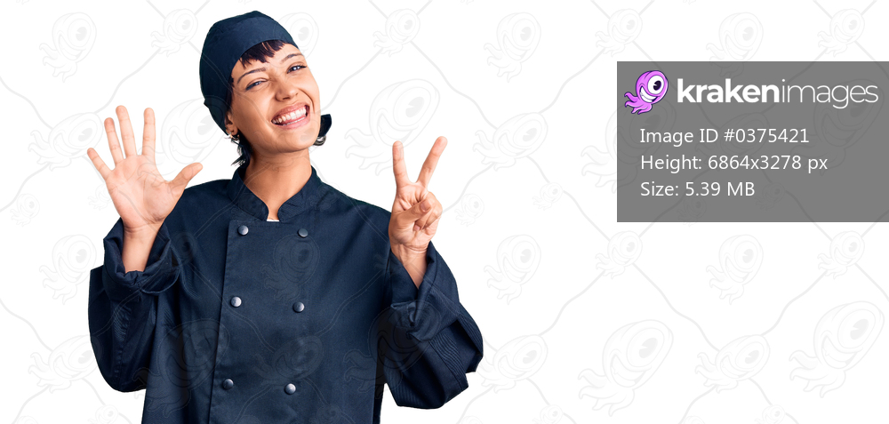 Young brunette woman with short hair wearing professional cook uniform showing and pointing up with fingers number seven while smiling confident and happy. 