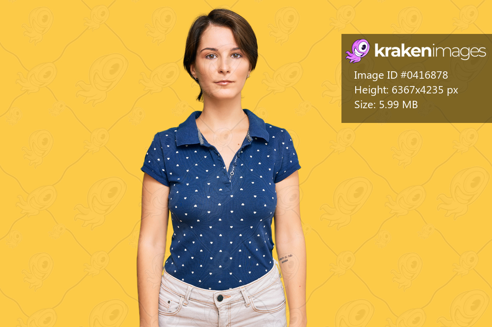 Young brunette woman with short hair wearing casual clothes relaxed with serious expression on face. simple and natural looking at the camera. 