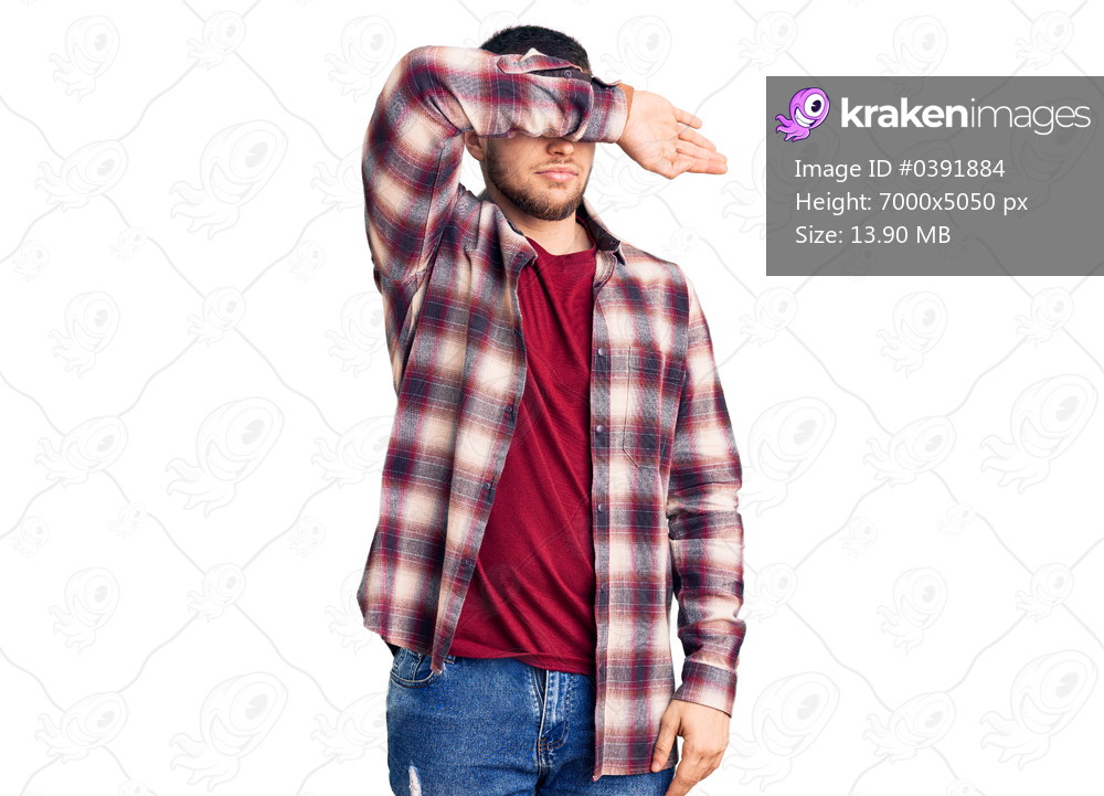 Young handsome man wearing casual shirt covering eyes with arm, looking serious and sad. sightless, hiding and rejection concept 