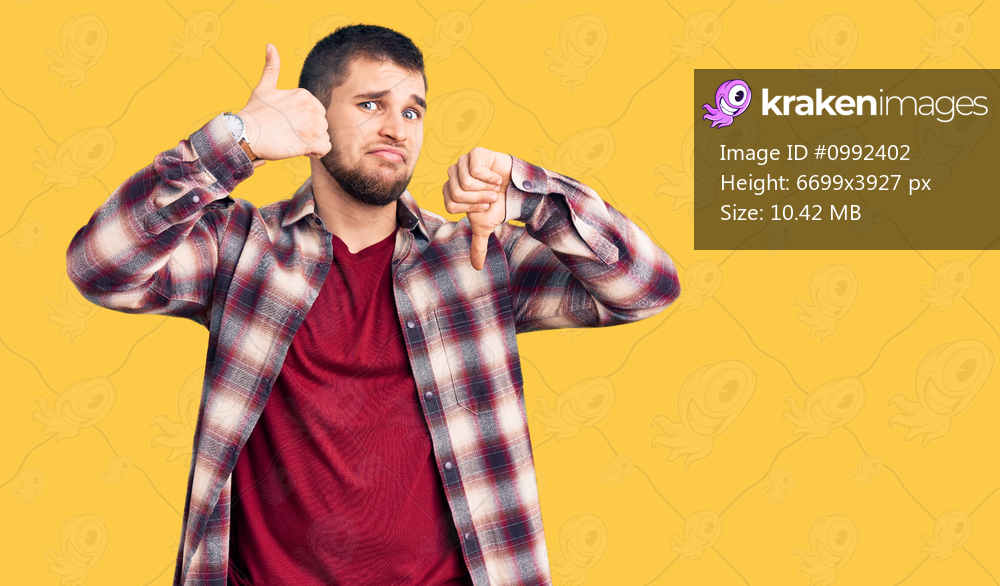 Young handsome man wearing casual shirt doing thumbs up and down, disagreement and agreement expression. crazy conflict 