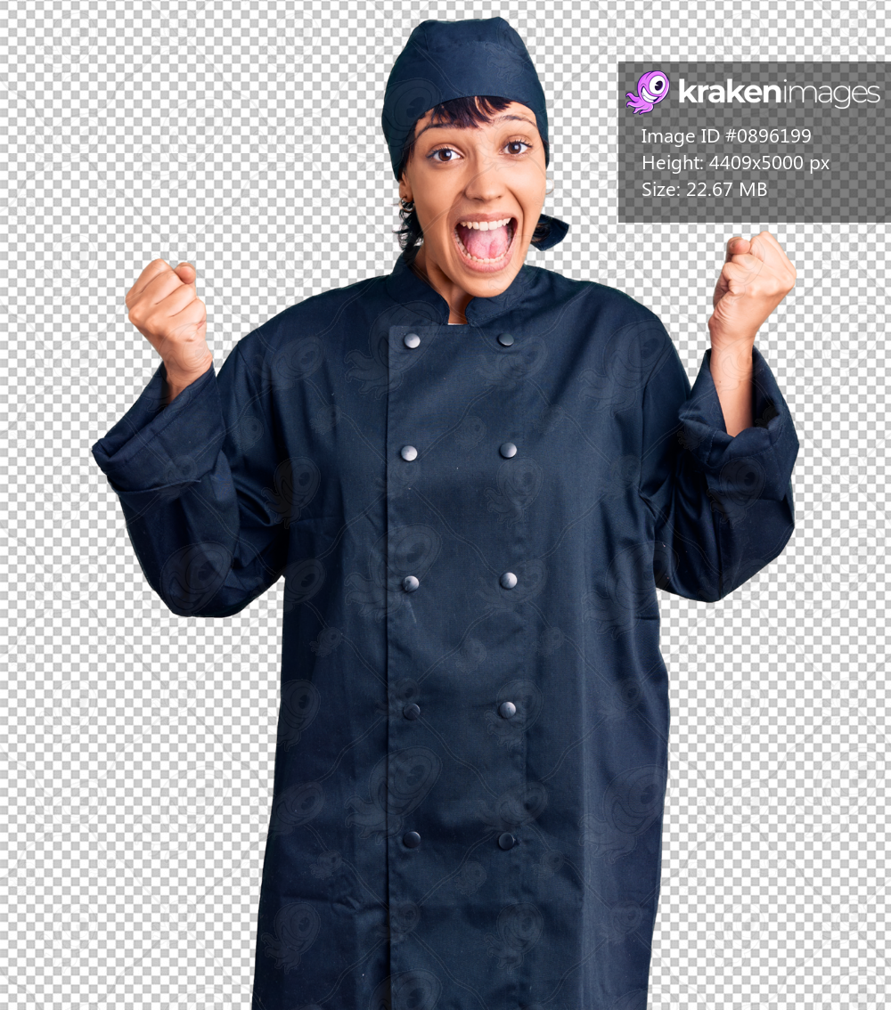 Young brunette woman with short hair wearing professional cook uniform celebrating surprised and amazed for success with arms raised and open eyes. winner concept.